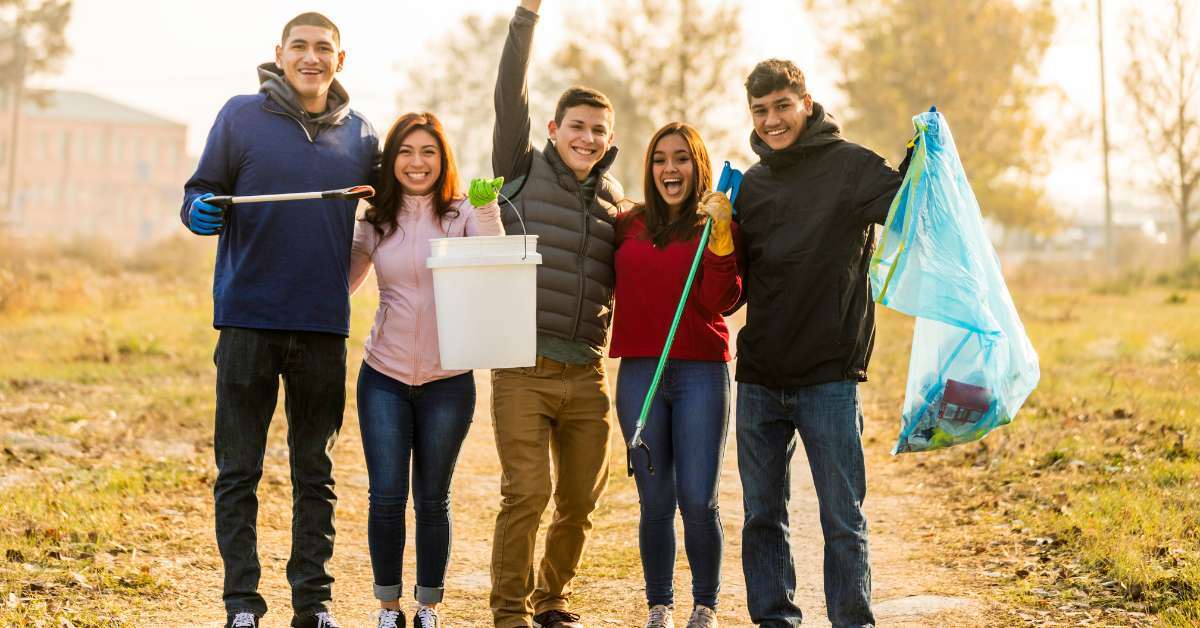 A group of social activist pose together while performing community service.